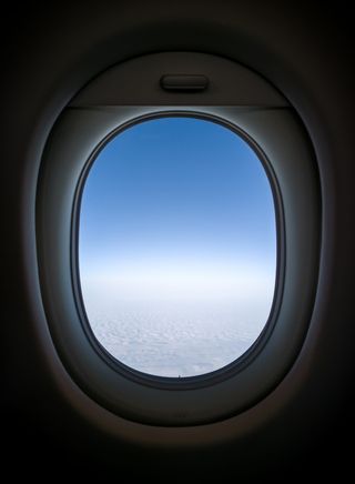 从飞机的窗口可以看到晴朗的天空