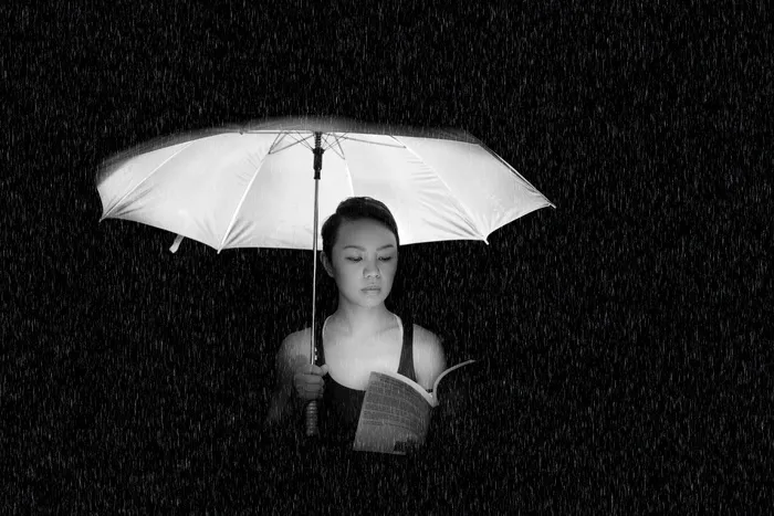 拿伞的女人灰度照片