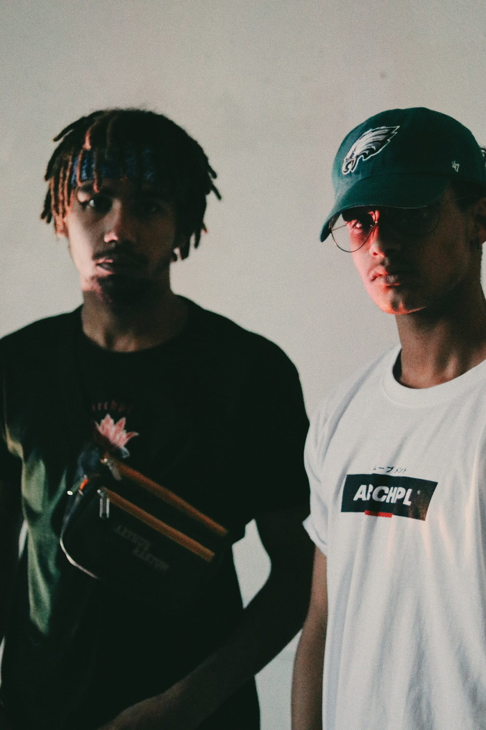 two man wearing white and black shirts