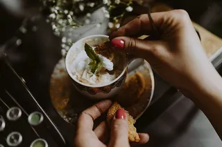 咖啡装在一个装饰性的杯子里，上面有金色的装饰物