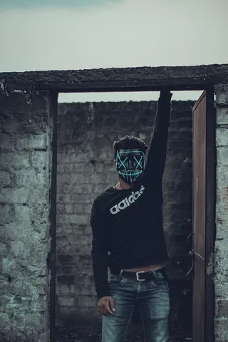 男子身穿黑色阿迪达斯长袖衬衫，戴口罩