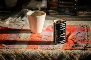 白色马克杯旁的黑色老板罐