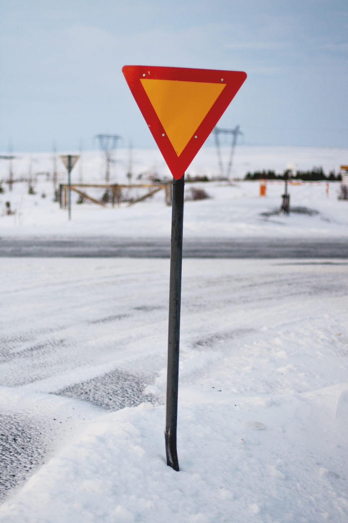 积雪道路旁的三角形路标