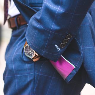 穿着蓝色格子西装夹克和连衣裙裤子的人