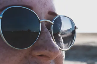 戴灰色镜框太阳镜的人