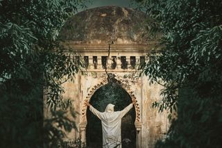 穿着白色连帽外套的人在白色拱门下