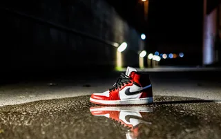 红白相间的Air Jordan 1运动鞋，水泥地面