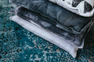 设计师设计的客厅内部有一张木箱桌和一块浅蓝色地毯