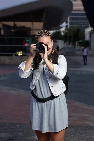 女人站立和使用数码单反相机