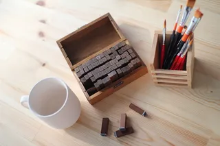 书桌，印章，铅笔，杯子，姓名首字母，还有most，刷子，木质材料