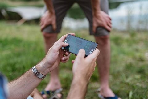 男子手在手机上玩电子游戏的特写镜头