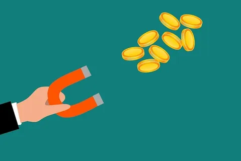 磁铁吸引金属硬币的插图。