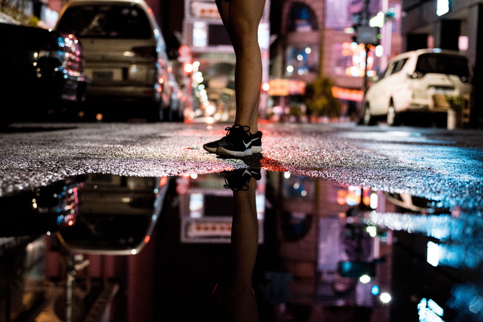 站在水体附近沥青路面上的人员