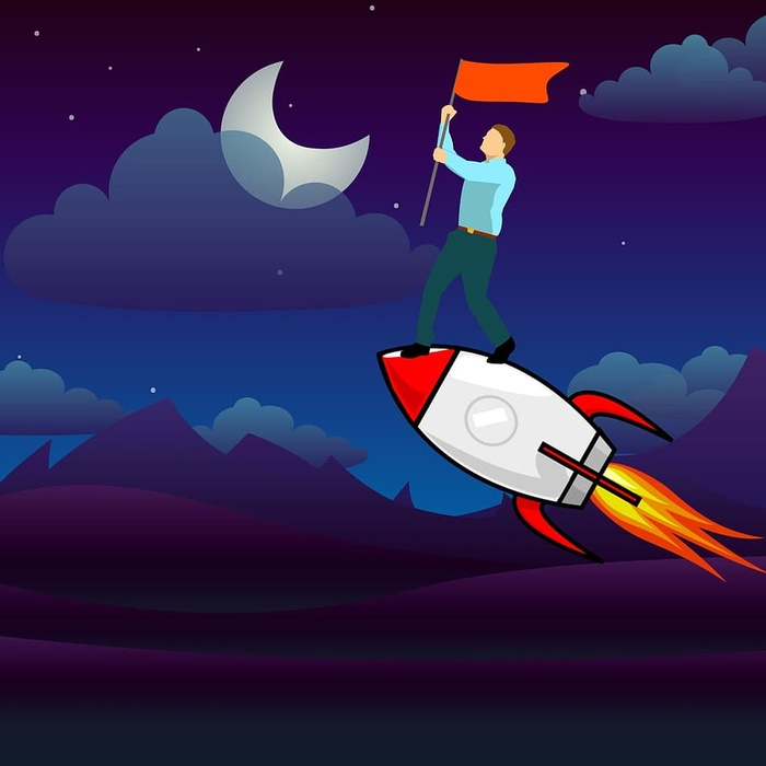 取得巨大成就后，站在火箭上举着国旗的人。