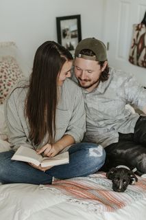 女人在床上一个男人旁边看书