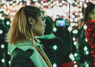 戴眼镜和黑白羊毛大衣的女性的选择性聚焦摄影