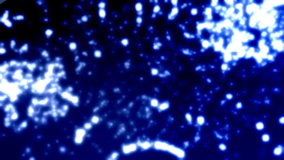 明亮的深蓝色的背景运动粒子的闪光