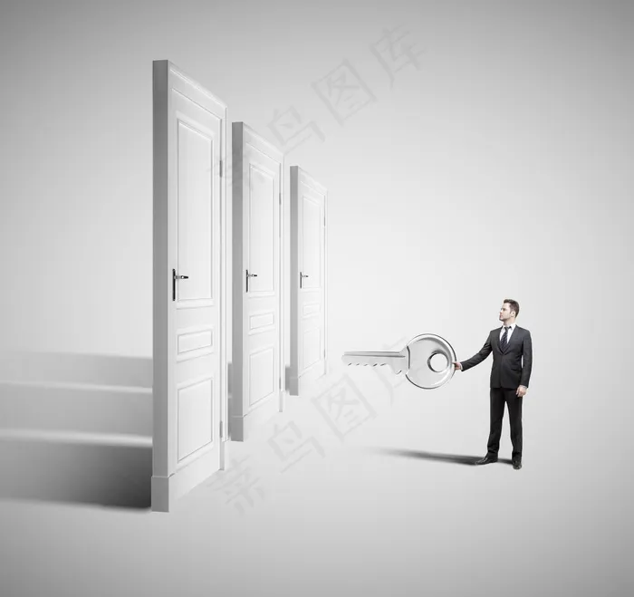 拿着钥匙开门的白领男士