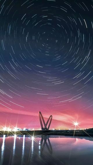 延时拍摄星空下的大桥高清摄影图片
