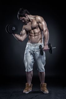 用哑铃展示肌肉的男人