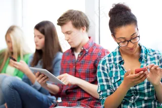 看手机和平板电脑的外国人