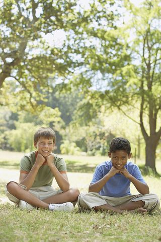 坐在草地上的上男孩图片