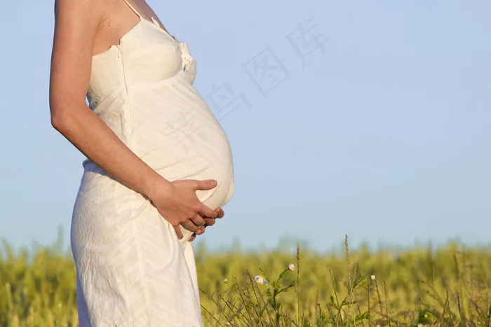 草地上摸肚子的孕妇图片