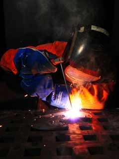 钢铁工人,熊熊大火,森林火灾,灯笼,篝火,水手在两栖船坞登陆舰上用弧焊焊接法兰。