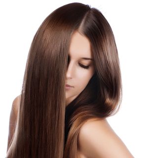 一位美丽的年轻女子的特写肖像，她有着优雅的闪亮长发