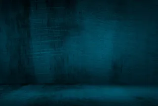 复古格伦蓝色混凝土纹理工作室墙壁背景与渐晕。