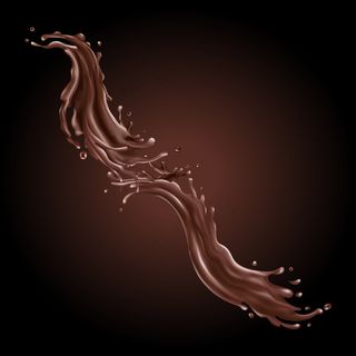 液体巧克力飞溅在黑色背景上