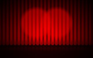 闭合的红幕舞台背景聚光灯光束照亮了戏剧窗帘
