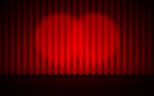 闭合的红幕舞台背景聚光灯光束照亮了戏剧窗帘 闭合的红幕舞台背景聚光灯光束照亮了戏剧窗帘