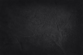 深灰色黑色板岩纹理，背景为天然黑色石墙。