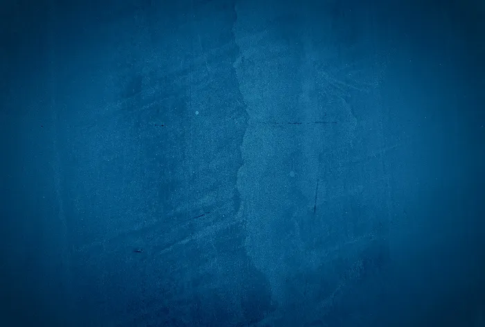 复古格伦蓝色混凝土纹理工作室墙壁背景与渐晕。