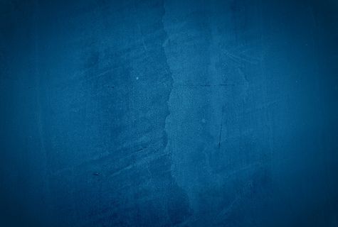 复古格伦蓝色混凝土纹理工作室墙壁背景与渐晕。