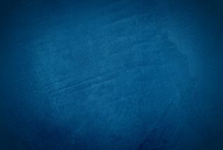 复古格伦蓝色混凝土纹理工作室墙壁背景与渐晕。