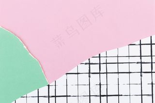 网格图案背景上的粉红色撕纸
