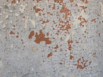 旧漆铁墙的表面纹理，油漆剥落。