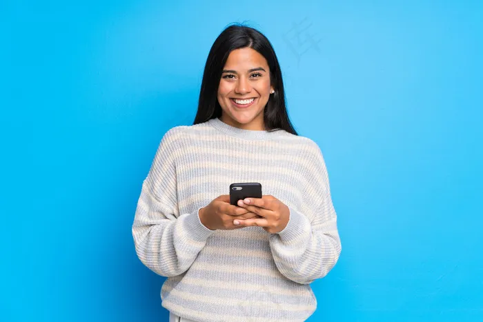 穿着毛衣的哥伦比亚女孩用手机发信息