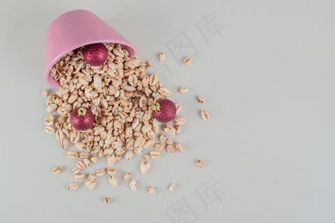 装满健康麦片和圣诞球的粉红色桶。
