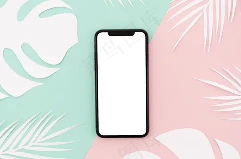 平板智能手机模型样机，桌上有树叶