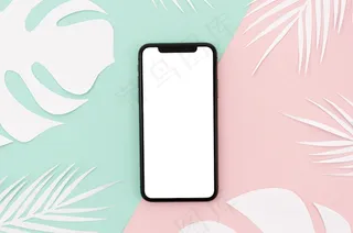 平板智能手机模型样机，桌上有树叶