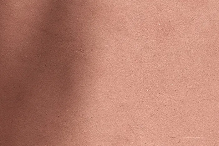 具有水泥质地的阴影粉红色背景