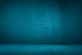 复古格伦蓝色混凝土纹理工作室墙壁背景与渐晕。