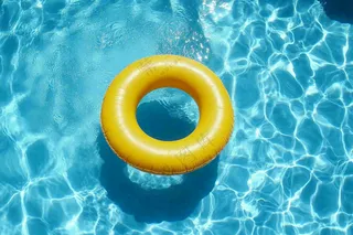 蓝色游泳池的黄色游泳圈摄影图