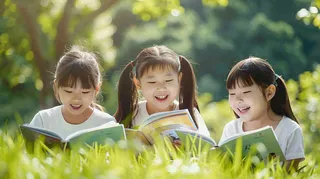 公园草坪看书阅读的学生孩子们知识兴趣世界读书日摄影图