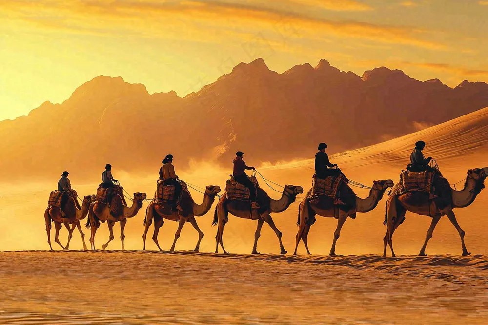 夕阳沙漠里骑骆驼的人群黄土沙丘大漠风光摄影图