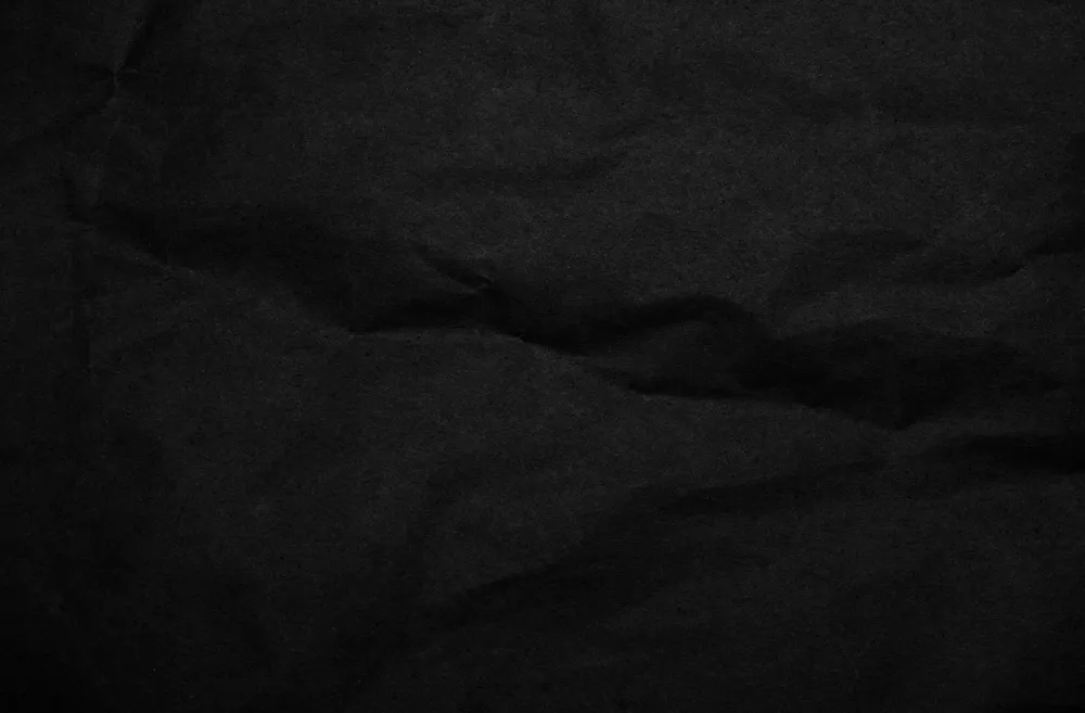 黑色褶皱痕迹纸张质感背景
