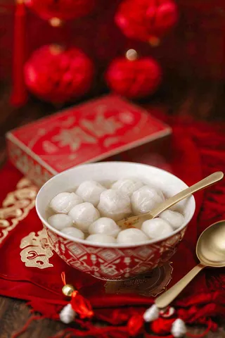 红色节日喜庆背景传统美食汤圆元宵节摄影图